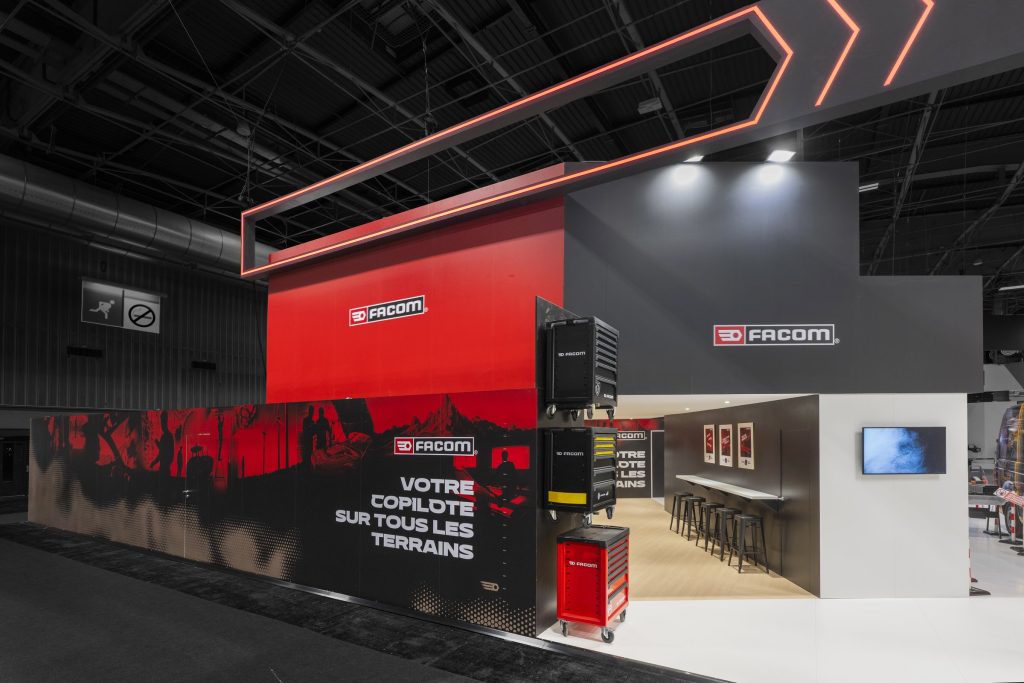 Photo d'un côté du stand avec accès au bar du stand sur-mesure Facom réalisé par R2 Stand sur le salon